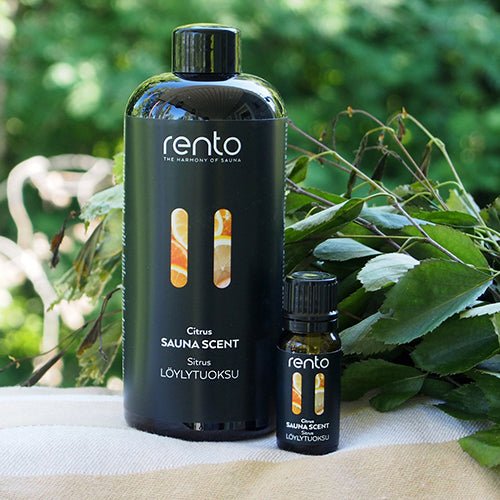 Rento Citrus Finnish sauna scent bottle displayed beside a natural branch for refreshing Nordic sauna aromatherapy.